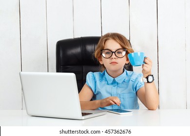 Young beautiful girl sitting at working place in office.
