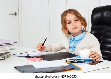 Young beautiful girl sitting at working place in office.