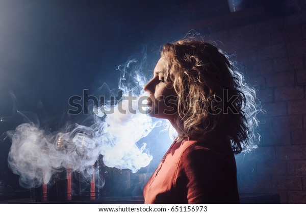 Young Beautiful Girl Smokes Hookah Produces Stock Photo