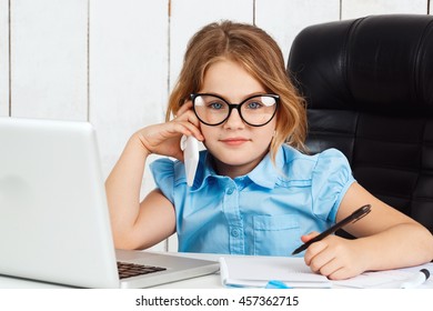 Young beautiful girl speaking phone at working place in office.