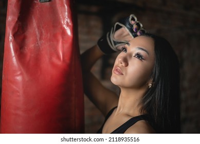 A Young Beautiful Girl Is Standing Near The Punching Bag Close Up Portrait.