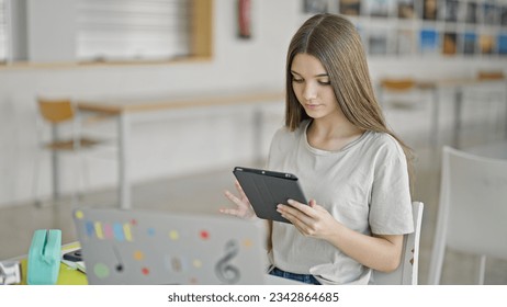 Young beautiful girl student using laptop and touchpad studying at library - Powered by Shutterstock