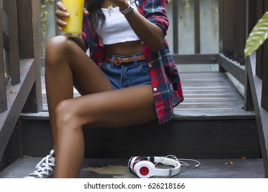 Young Beautiful Girl In Stylish Sunglasses And With A Fashionable Lingerie Top And Jeans Shorts At Sunset Over Pool,blue Background, Vintage Accesories And Blue Wool Top.Street Style.mint Blue