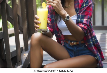 Young Beautiful Girl In Stylish Sunglasses And With A Fashionable Lingerie Top And Jeans Shorts At Sunset Over Pool,blue Background, Vintage Accesories And Blue Wool Top.Street Style.mint Blue