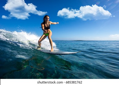 young beautiful girl surf on the big waves in the open ocean. Mauritius Island