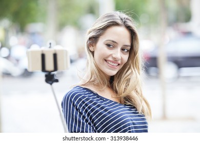 Young Beautiful Girl Taking Selfie Stick Picture Happy On Sunny Day