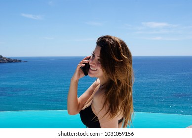 Young Beautiful Girl Talking On The Phone In A Luxury Villa In Ibiza