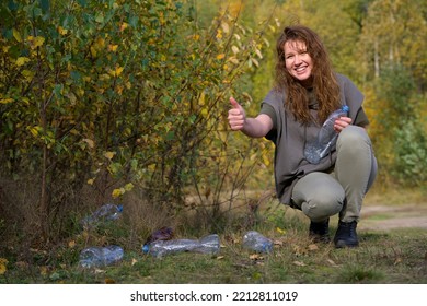 Young Beautiful Girl Volunteer, Woman Collecting Spilled Trash Garbage, Female Hand Cleaning Up Used Plastic Bottles In Forest Or Park. Ecology, Environmental Conservation, Pollution. Recycling Reduce