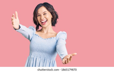 Young Beautiful Girl Wearing Casual Clothes Smiling Cheerful Offering Hands Giving Assistance And Acceptance. 