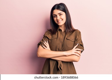 Young beautiful girl wearing casual dress happy face smiling with crossed arms looking at the camera. positive person. 