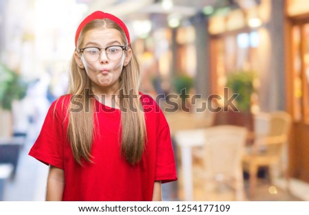 Young beautiful girl wearing glasses over isolated background making fish face with lips, crazy and comical gesture. Funny expression.