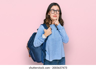 Young beautiful girl wearing student backpack serious face thinking about question with hand on chin, thoughtful about confusing idea  - Powered by Shutterstock