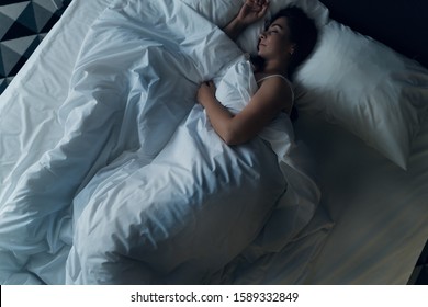 Young Beautiful Girl Or Woman Sleeping Alone In Big Bed At Night, Top View.