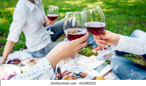 Young Beautiful Girls With Glass Of Red Wine In The Park. Nature Background