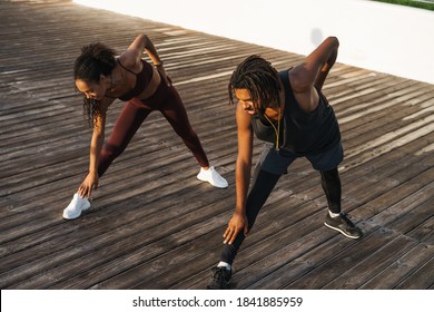 Young Beautiful Happy African American Man And Woman Doing Workout Outdoors