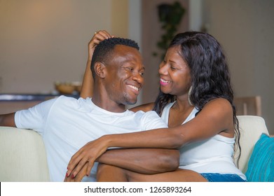 young beautiful and happy black afro American couple in love relaxed at home living room sofa couch smiling cheerful having fun relaxed and homey in successful relationship and bonding concept - Shutterstock ID 1265893264