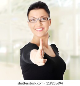 Young beautiful happy caucasian woman pointing on you . Focus on hand - Shutterstock ID 119235694