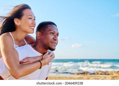 Young beautiful having fun couple on the sea background - Shutterstock ID 2046409238