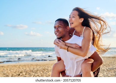 Young beautiful having fun couple on the sea background - Shutterstock ID 2057120705
