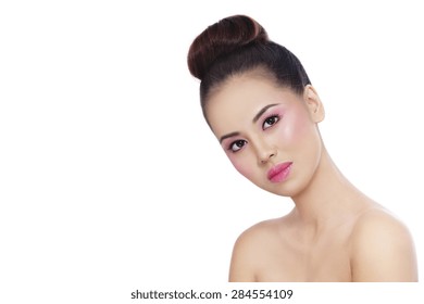 Young Beautiful Healthy Asian Girl With Shiny Pink Makeup And Hair Bun Over White Background, Copy Space