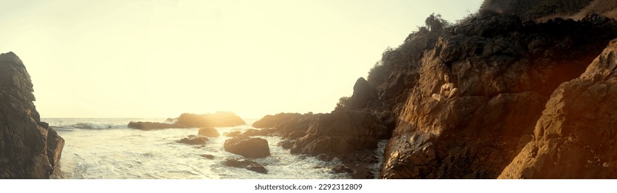 Young beautiful healthy woman making meditation on the rocks, sunset on the sea. Arambol, Goa, India. - Powered by Shutterstock