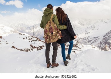 young beautiful hipster couple hiking in mountains, winter vacation traveling, man woman in love, romance, north, snow, warm clothes, jacket, anorak, view from back - Powered by Shutterstock