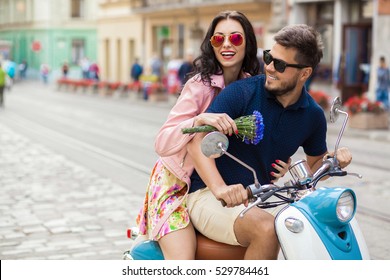 young beautiful hipster couple riding on motorbike city street, summer europe vacation, traveling, romance, smiling, happy, having fun, sunglasses, stylish outfit, together in love, adventures, date - Powered by Shutterstock