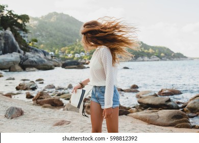 young beautiful hipster woman on summer vacation in asia, having fun on tropical beach, casual boho style, sea landscape background, slim tanned body, travel alone, long hair, smiling, happy, positive - Powered by Shutterstock