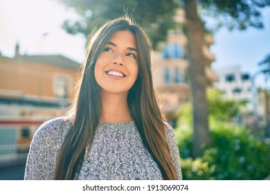 Young beautiful hispanic girl smiling happy walking at the city.