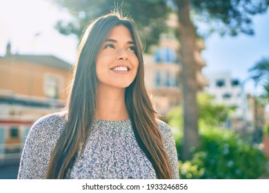 Young beautiful hispanic girl smiling happy walking at the city.