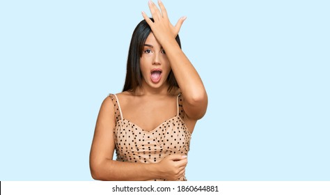 Young Beautiful Hispanic Girl Wearing Sexy Party Dress Surprised With Hand On Head For Mistake, Remember Error. Forgot, Bad Memory Concept. 