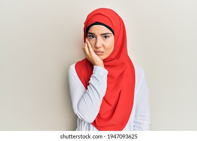 Young Beautiful Hispanic Girl Wearing Traditional Islamic Hijab Scarf Thinking Looking Tired And Bored With Depression Problems With Crossed Arms. 