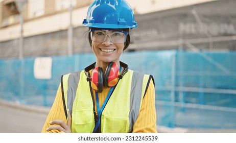 Young beautiful hispanic woman architect smiling confident standing with arms crossed gesture at street - Shutterstock ID 2312245539