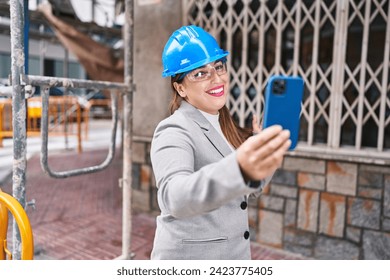 Young beautiful hispanic woman architect smiling confident having video call at street - Powered by Shutterstock