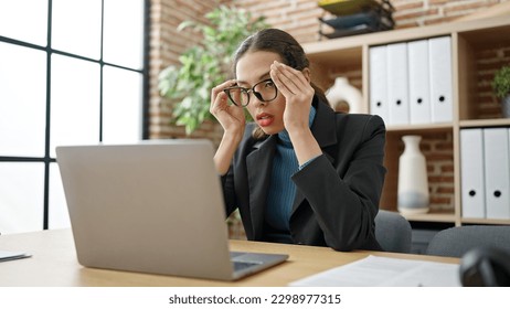 Young beautiful hispanic woman business worker stressed using laptop at office - Shutterstock ID 2298977315