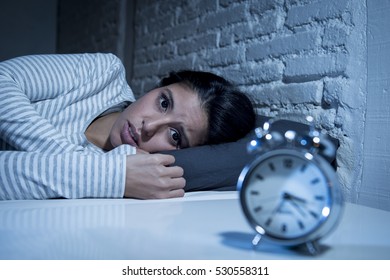young beautiful hispanic woman at home bedroom lying in bed late at night trying to sleep suffering insomnia sleeping disorder or scared on nightmares looking sad worried and stressed - Shutterstock ID 530558311