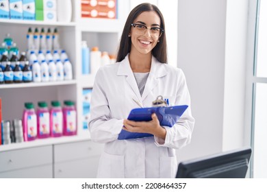 Young beautiful hispanic woman pharmacist writing on document at pharmacy - Powered by Shutterstock