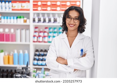 Young beautiful hispanic woman pharmacist smiling confident standing with arms crossed gesture at pharmacy - Powered by Shutterstock