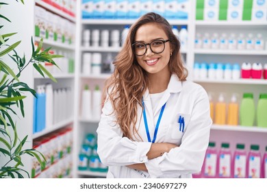 Young beautiful hispanic woman pharmacist smiling confident standing with arms crossed gesture at pharmacy - Powered by Shutterstock