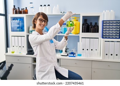 Young Beautiful Hispanic Woman Scientist Holding Test Tube At Laboratory