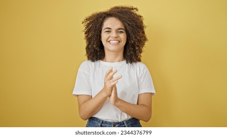 Young beautiful hispanic woman smiling confident clapping hands over isolated yellow background - Shutterstock ID 2344376799