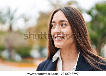 Young beautiful hispanic woman smiling confident looking to the side at park