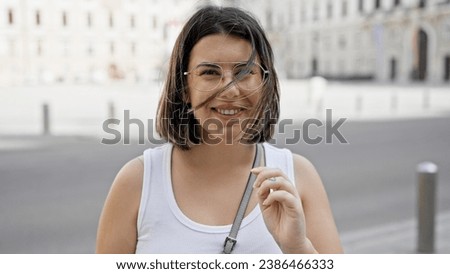 Young beautiful hispanic woman smiling confident standing in the streets of Vienna
