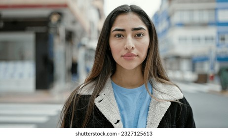 Young beautiful hispanic woman standing with serious expression at street - Powered by Shutterstock