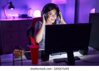 Young Beautiful Hispanic Woman Streamer Playing Video Game At Gaming Room