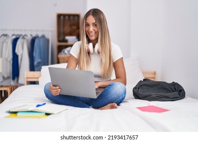 Young Beautiful Hispanic Woman Student Sitting On Bed Using Laptop At Bedroom