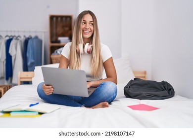 Young Beautiful Hispanic Woman Student Sitting On Bed Using Laptop At Bedroom