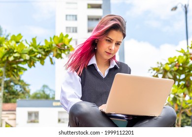 Young And Beautiful Hispanic Woman Using Her Laptop PC While Sitting On The Bench Outdoors.