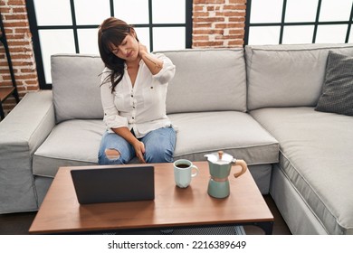 Young Beautiful Hispanic Woman Using Laptop Stressed At Home