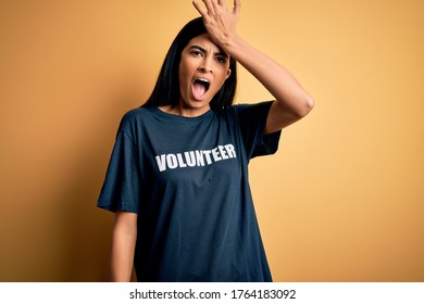 Young Beautiful Hispanic Woman Wearing Volunteer T-shirt As Social Charity Moral Surprised With Hand On Head For Mistake, Remember Error. Forgot, Bad Memory Concept.